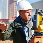 Surveyor,Builder,Worker,With,Theodolite,Transit,Equipment,At,Construction,Site